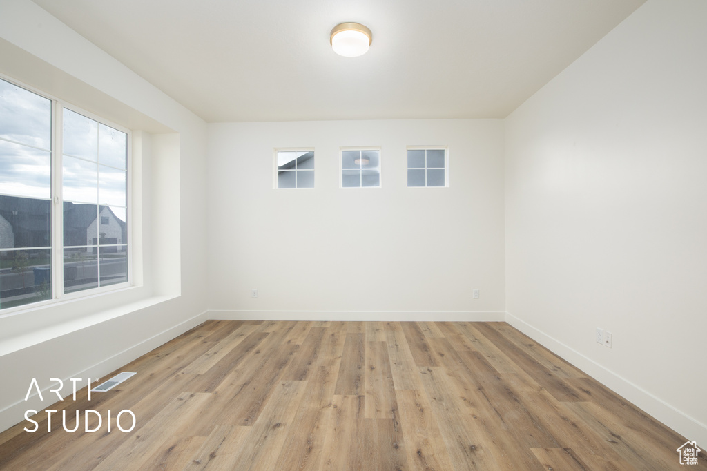 Empty room featuring hardwood / wood-style flooring