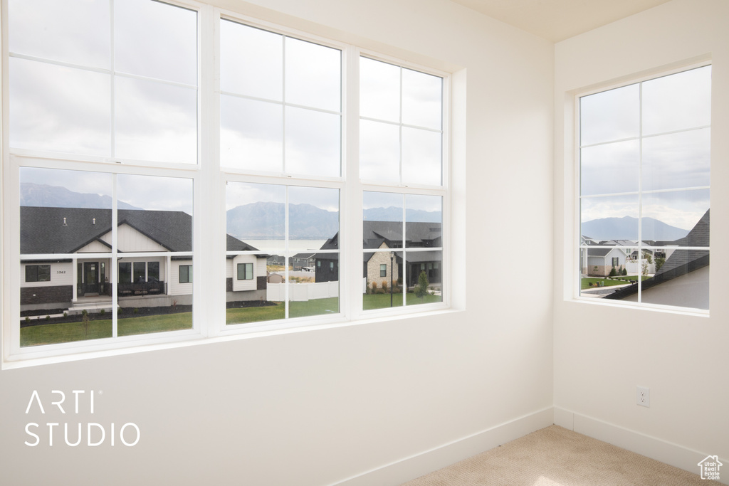 Empty room featuring carpet flooring and a mountain view