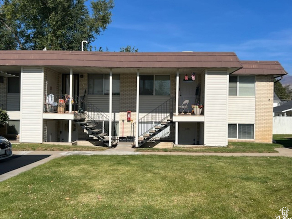 View of front of house featuring covered porch and a front lawn