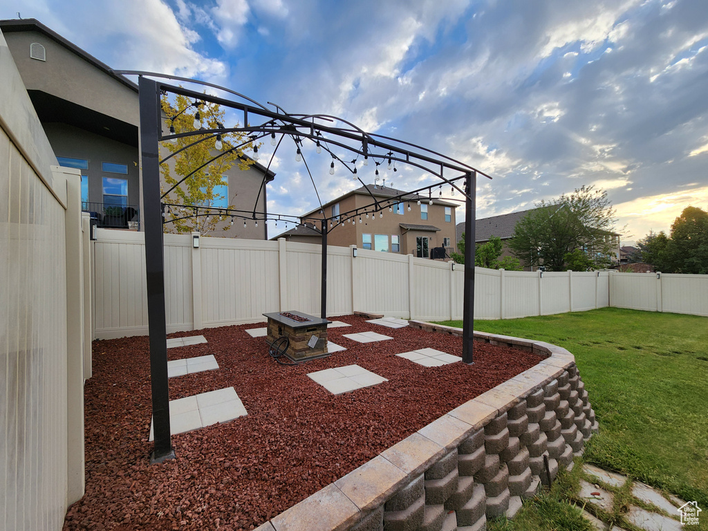 Yard at dusk featuring a fire pit