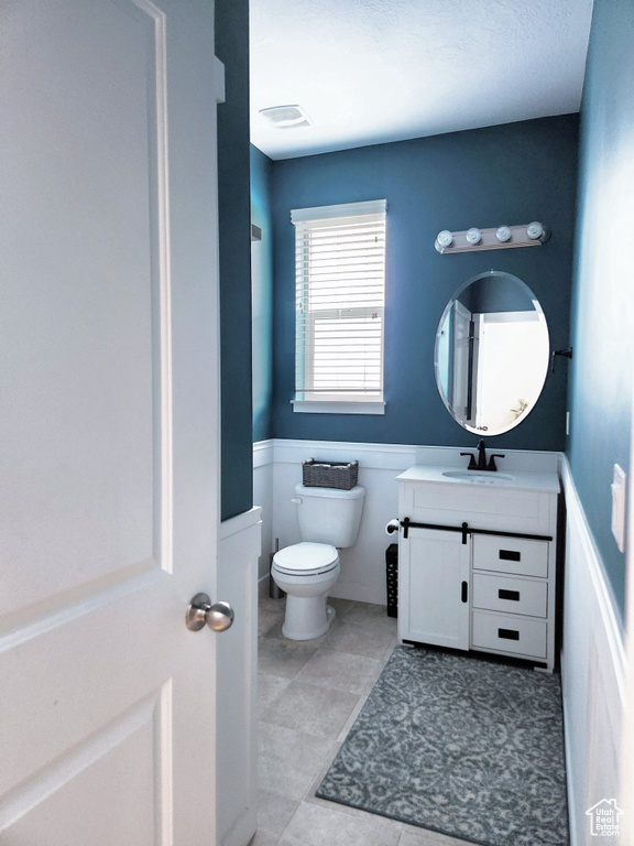 Bathroom featuring vanity and toilet