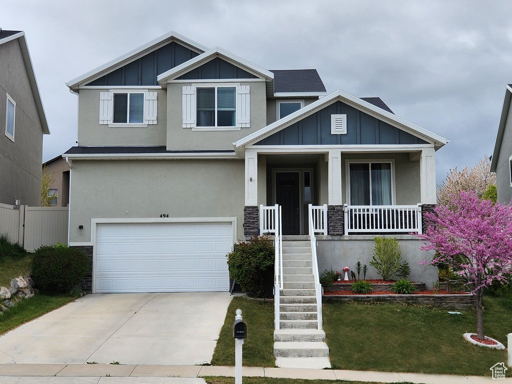 Craftsman-style house with a garage and a porch