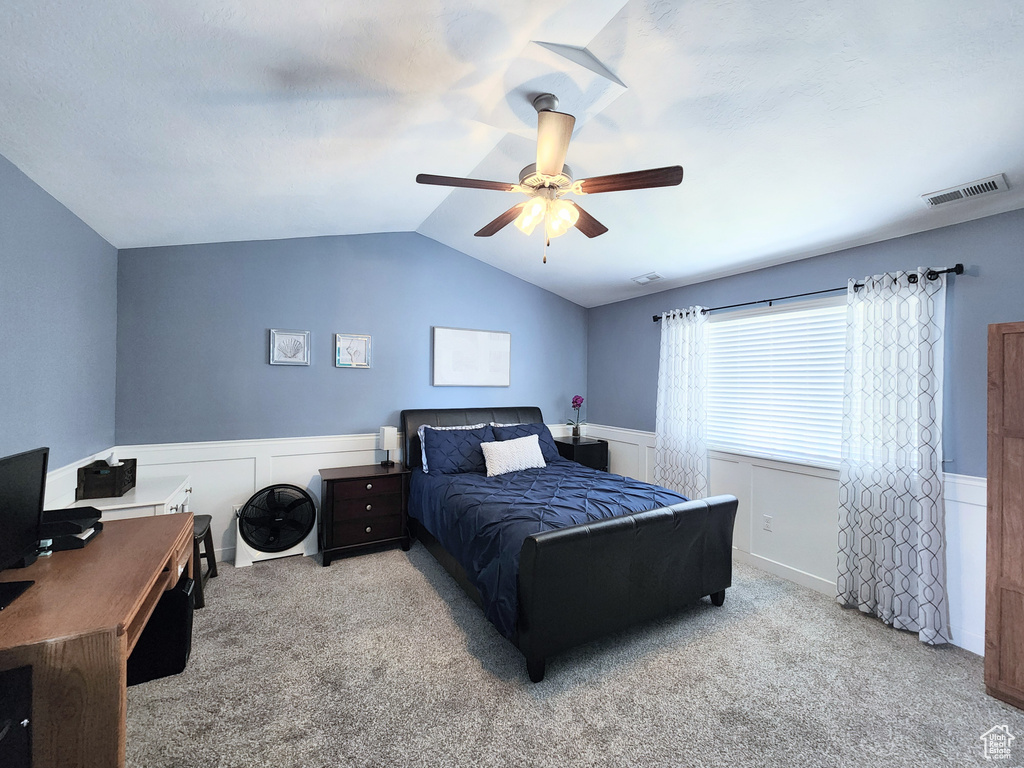 Bedroom featuring lofted ceiling, ceiling fan, and carpet floors