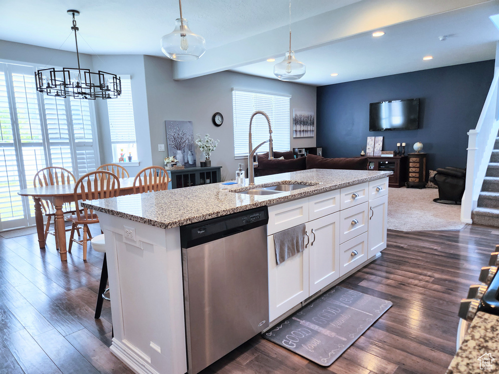 Kitchen featuring dark hardwood / wood-style floors, dishwasher, sink, a healthy amount of sunlight, and white cabinets