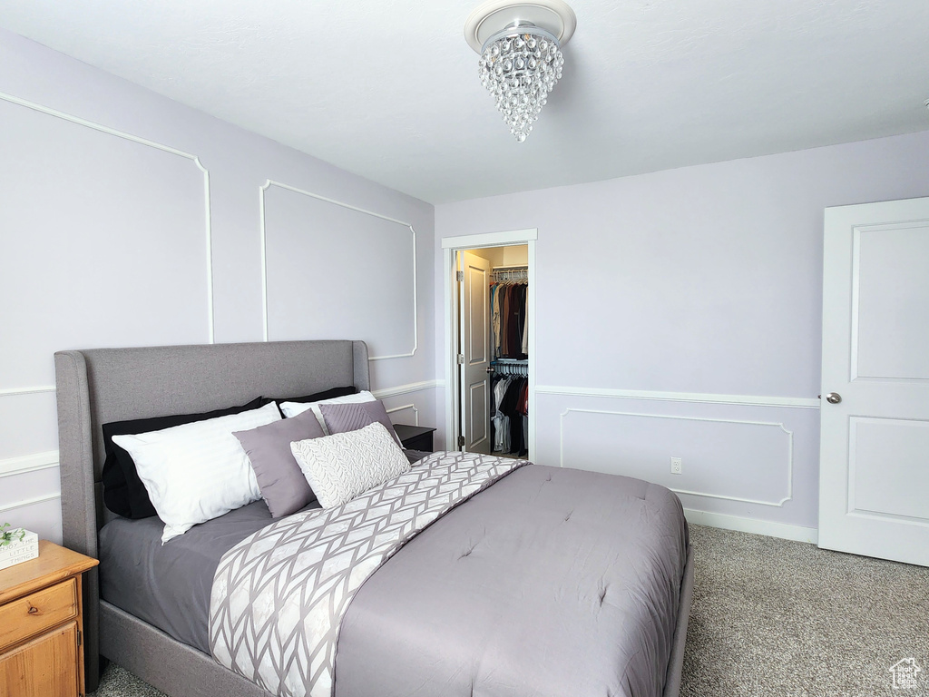 Bedroom with a closet, a spacious closet, and carpet floors