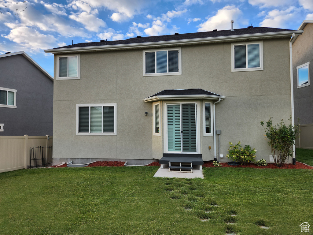 Rear view of house with a yard