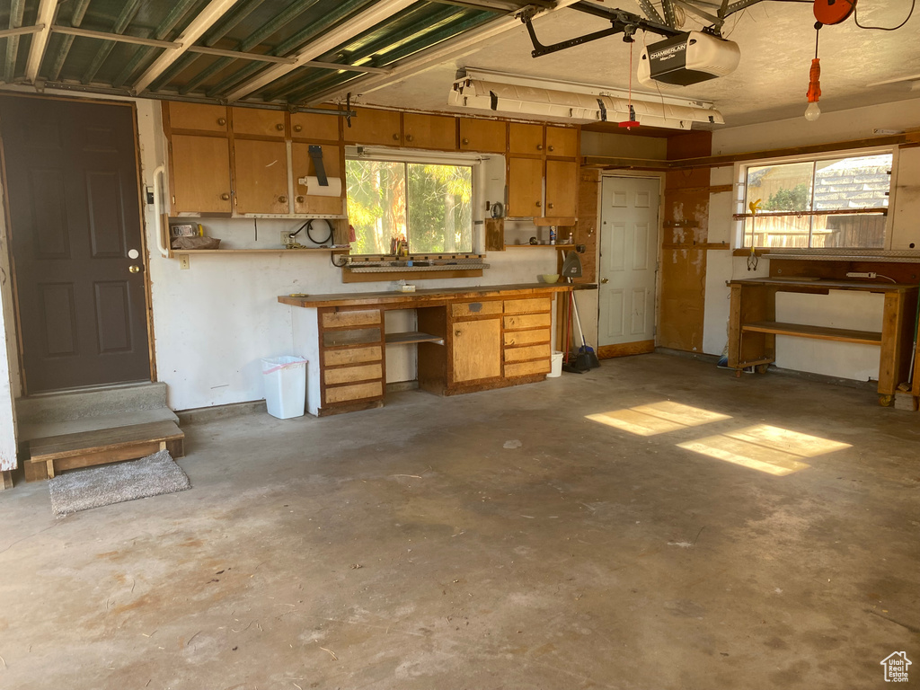 Garage with a garage door opener and a workshop area