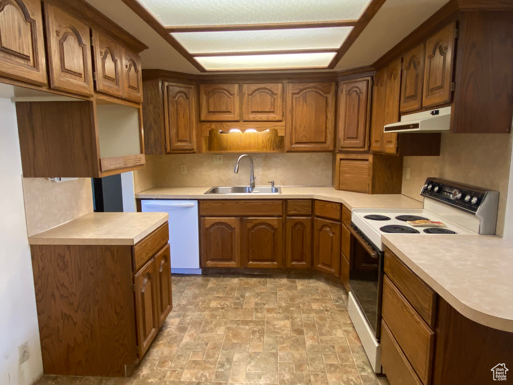 Kitchen featuring white appliances and sink