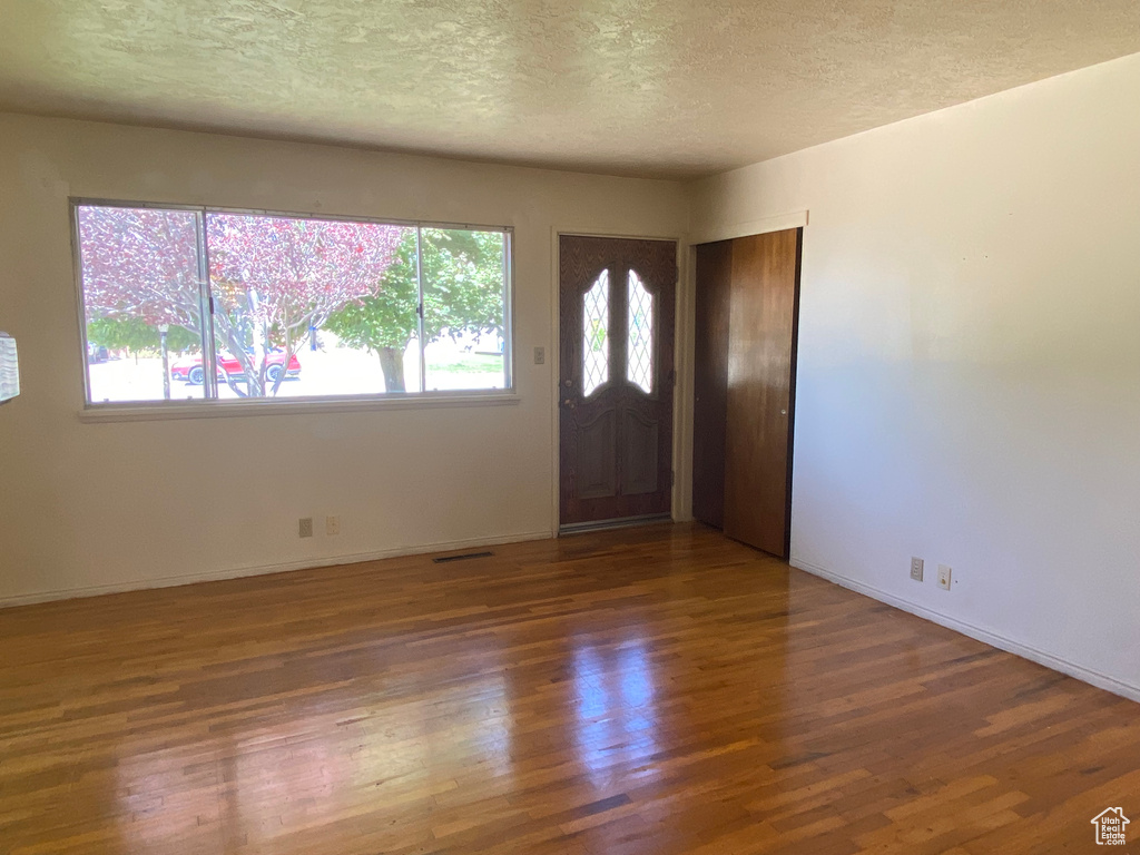 Entryway featuring dark wood-type flooring and a textured ceiling