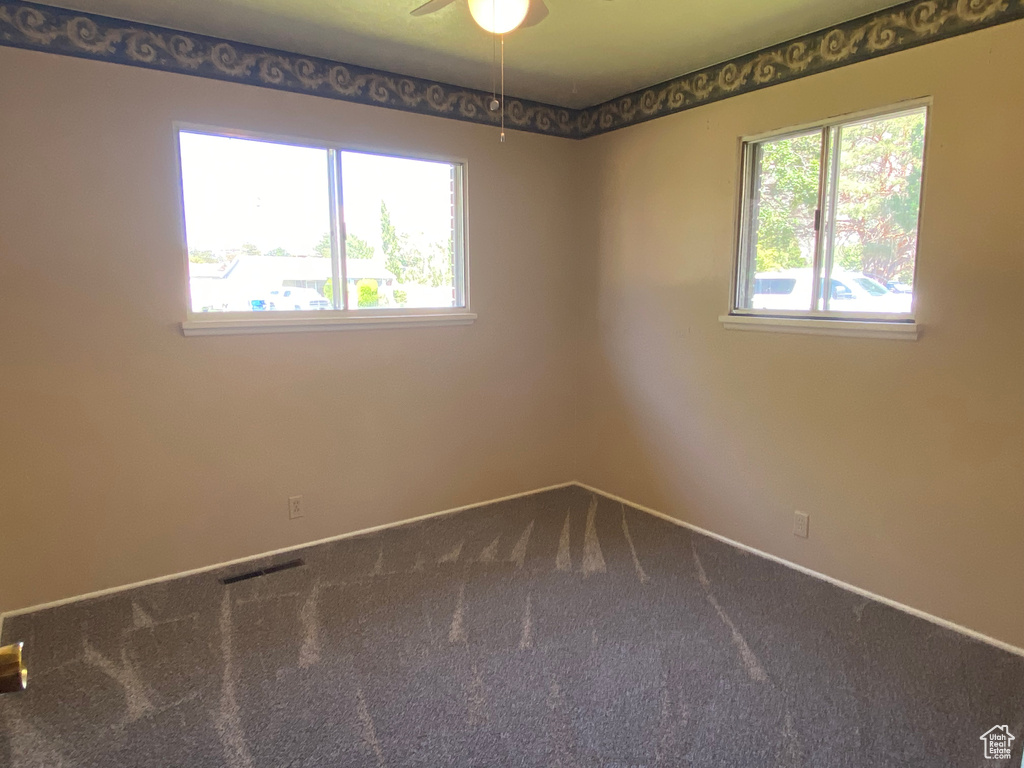 Spare room with carpet and ceiling fan