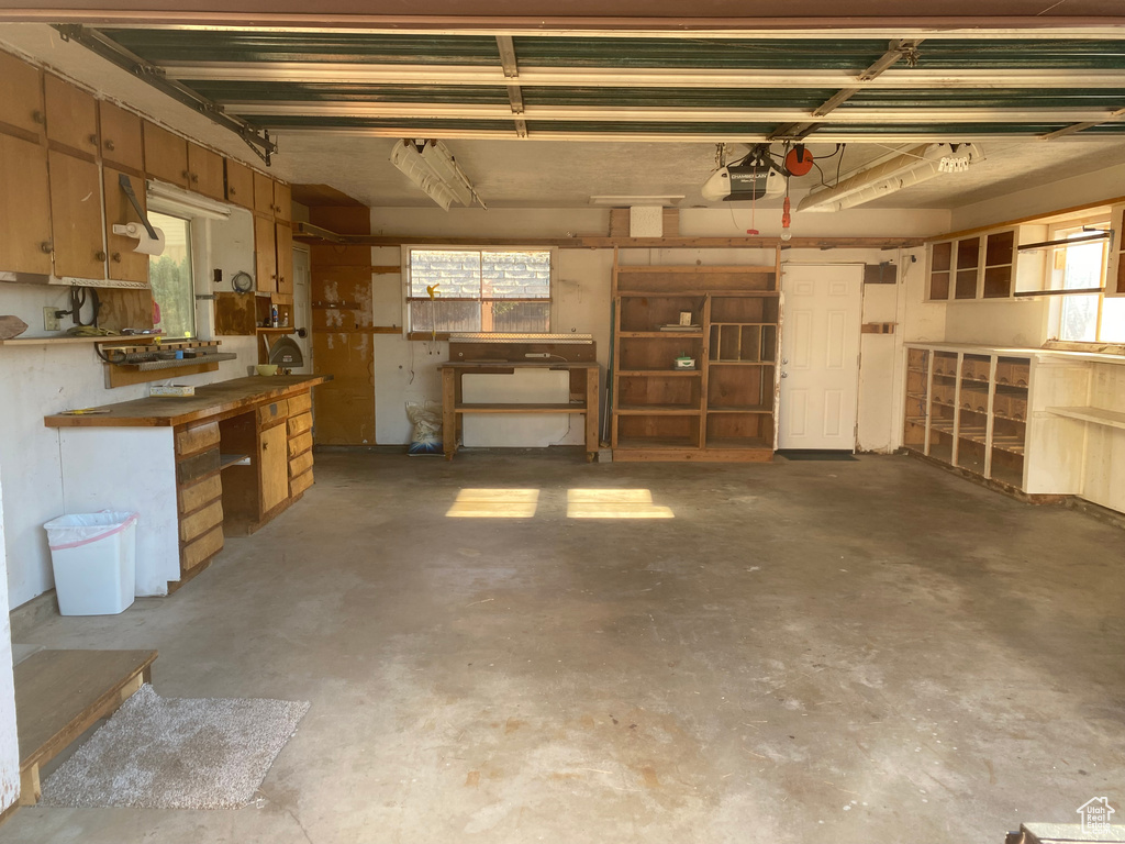 Garage featuring a garage door opener and a workshop area