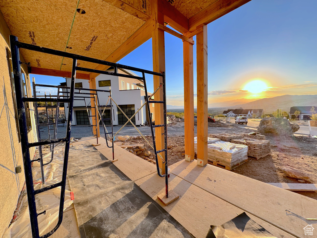 Patio terrace at dusk featuring a mountain view