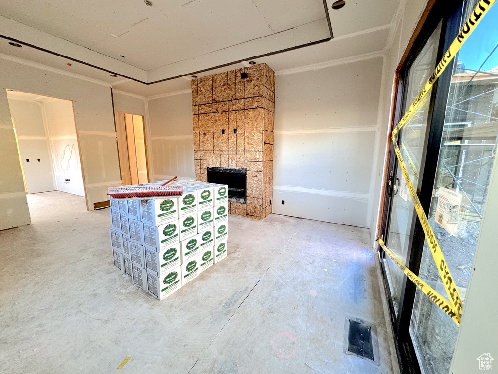 Unfurnished living room featuring a fireplace and concrete flooring