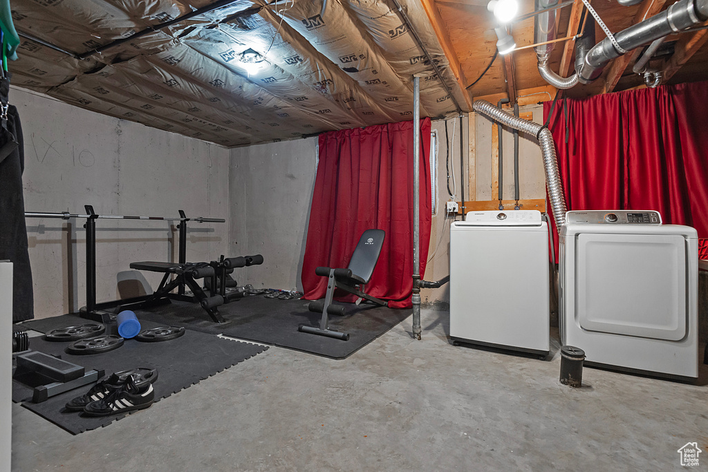 Exercise room featuring washing machine and clothes dryer