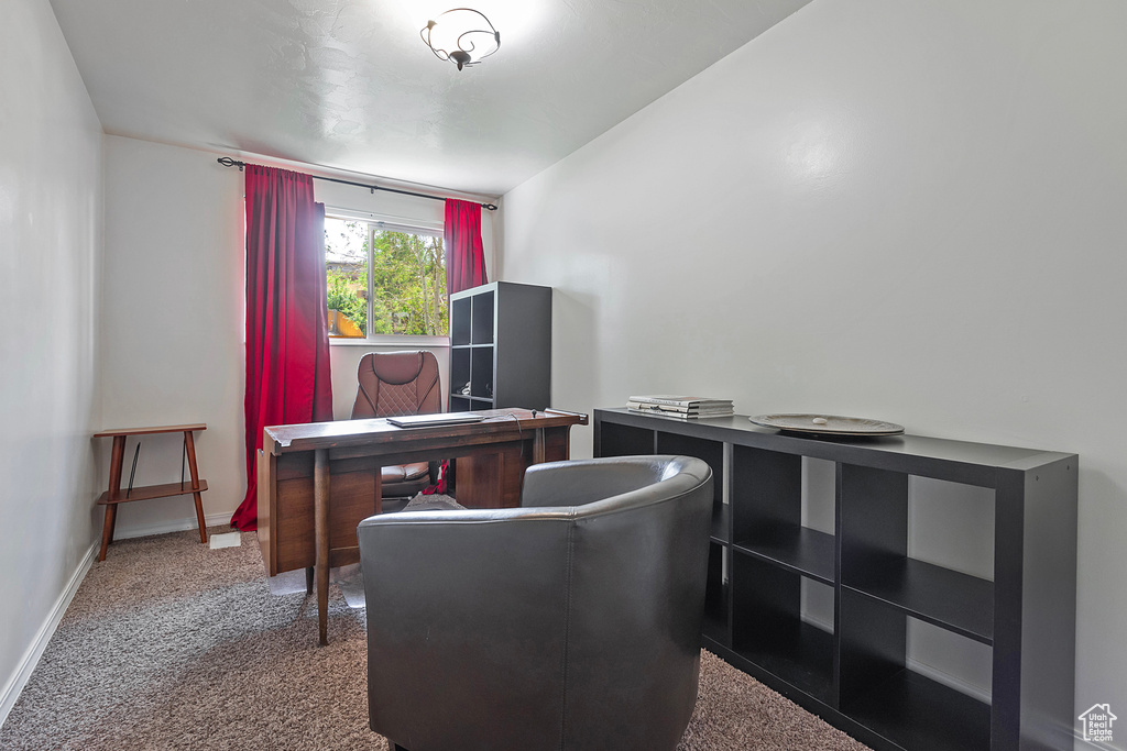 Office area featuring dark colored carpet