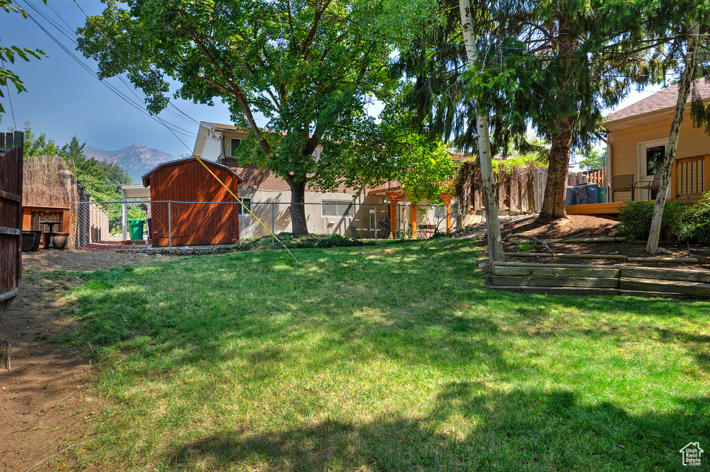 View of yard with a shed and a mountain view