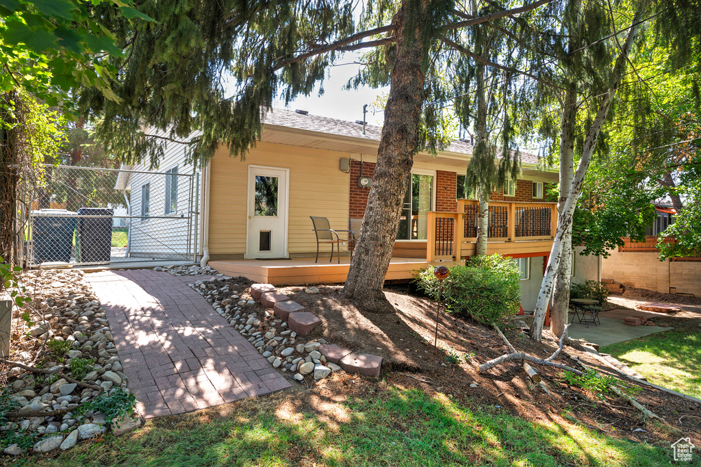 Back of house featuring a patio and a deck