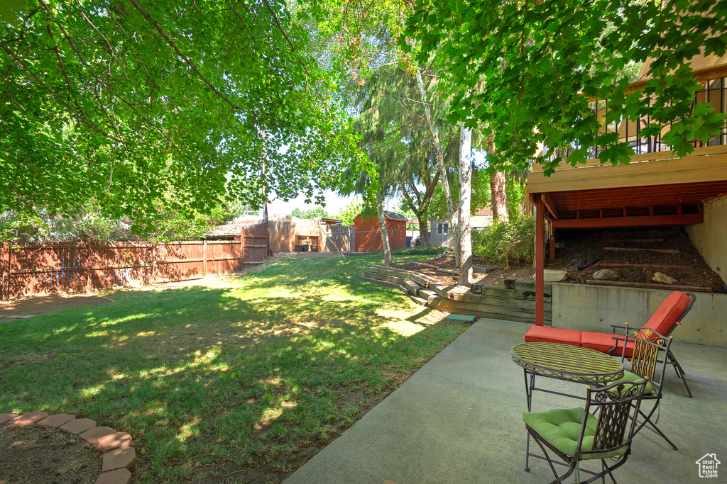 View of yard with a deck and a patio