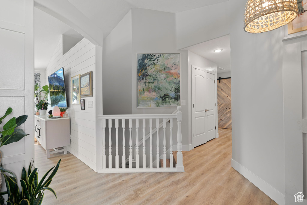 Hall with light hardwood / wood-style floors