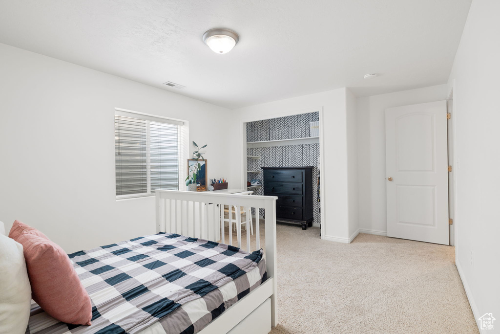 Carpeted bedroom featuring a fireplace