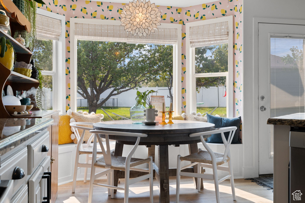 Dining area featuring light hardwood / wood-style flooring, a chandelier, and a healthy amount of sunlight