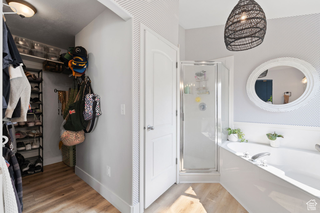 Bathroom with wood-type flooring and plus walk in shower