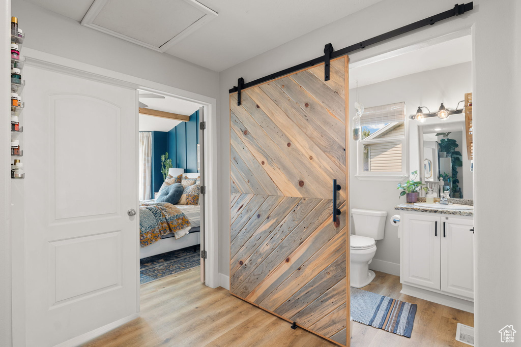 Bathroom with vanity, toilet, and hardwood / wood-style flooring