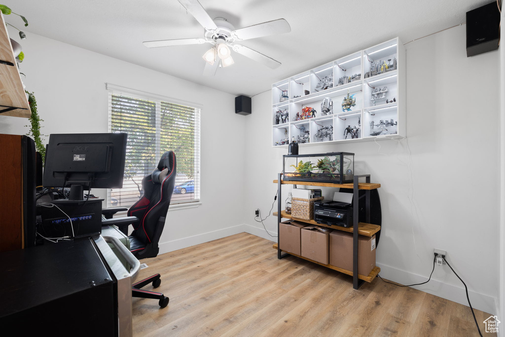 Office space with ceiling fan and light wood-type flooring