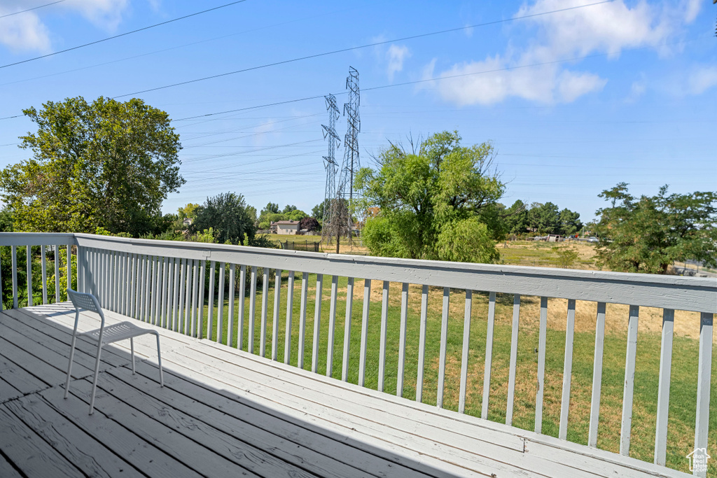 Wooden terrace featuring a lawn