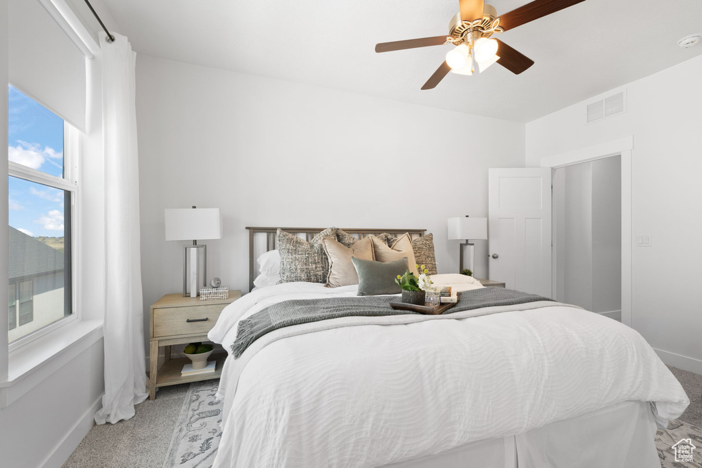 Bedroom featuring ceiling fan and light carpet