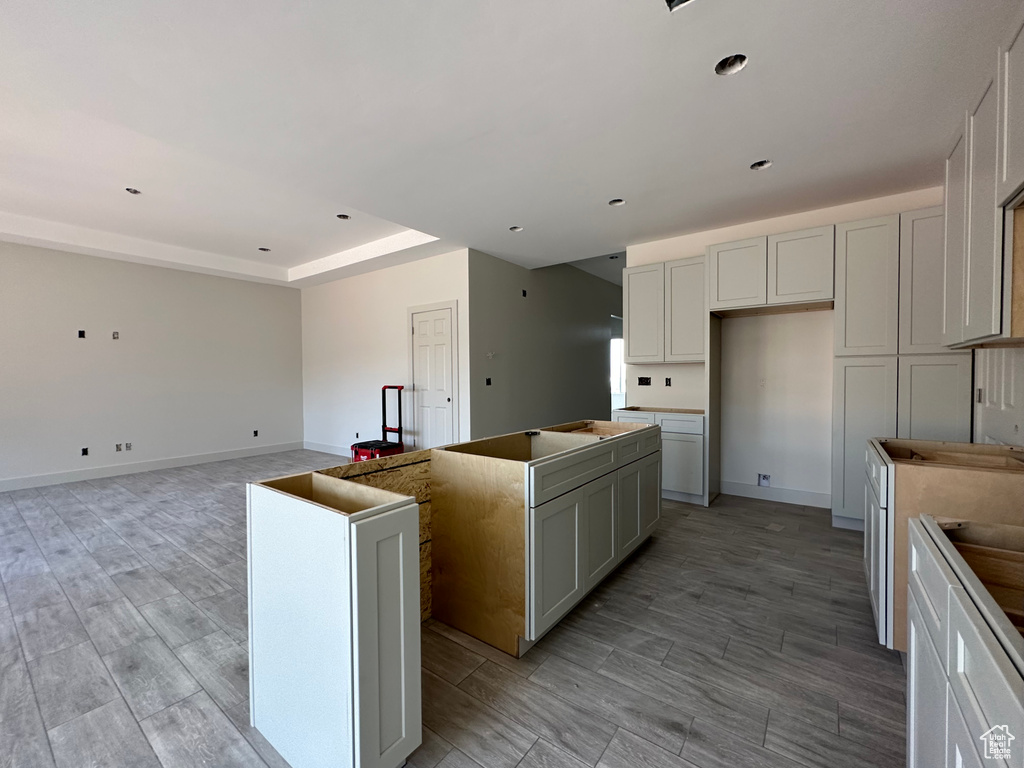 Kitchen featuring a center island, white cabinetry, and light hardwood / wood-style floors