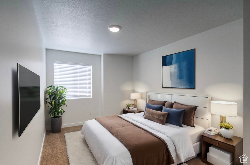 Bedroom with light carpet and a textured ceiling