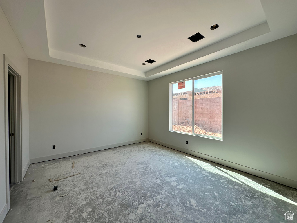 Unfurnished room featuring a raised ceiling