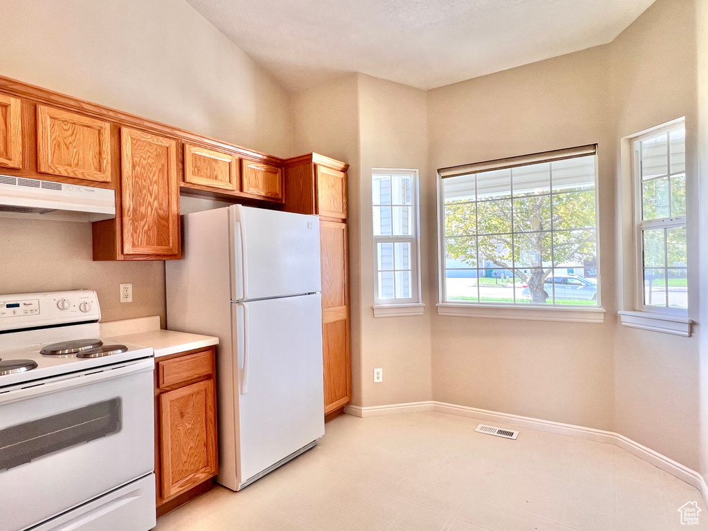 Kitchen featuring white appliances