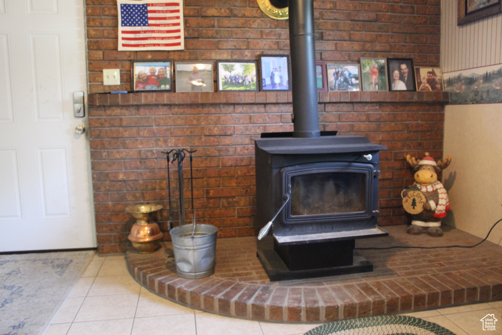 Details with a wood stove and tile patterned flooring