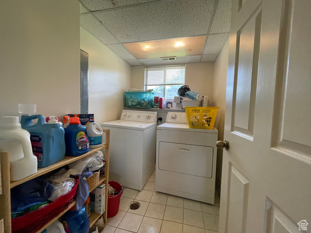 Laundry room featuring washing machine and dryer and light tile patterned flooring