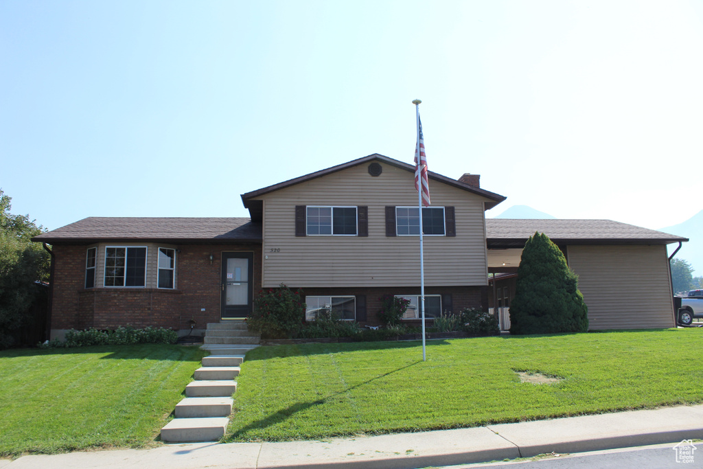 Split level home featuring a front yard