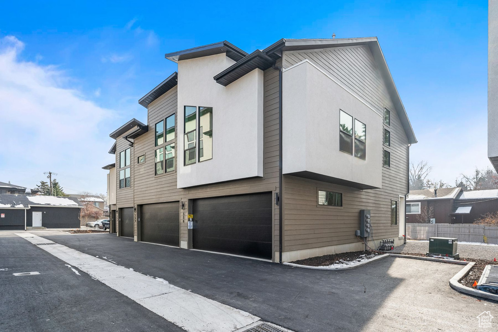 View of side of home with a garage