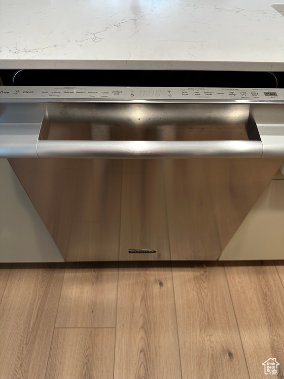 Details featuring dishwasher and light hardwood / wood-style floors