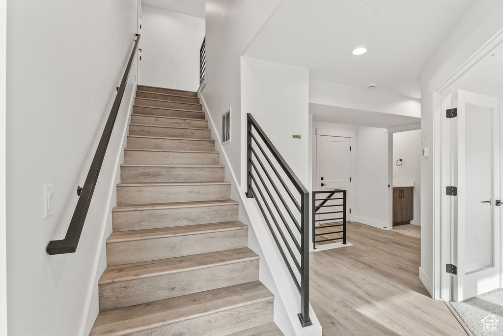 Stairs with hardwood / wood-style flooring