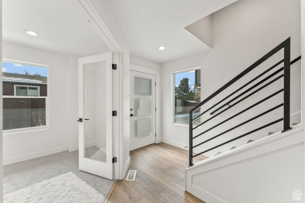 Entrance foyer with light hardwood / wood-style flooring