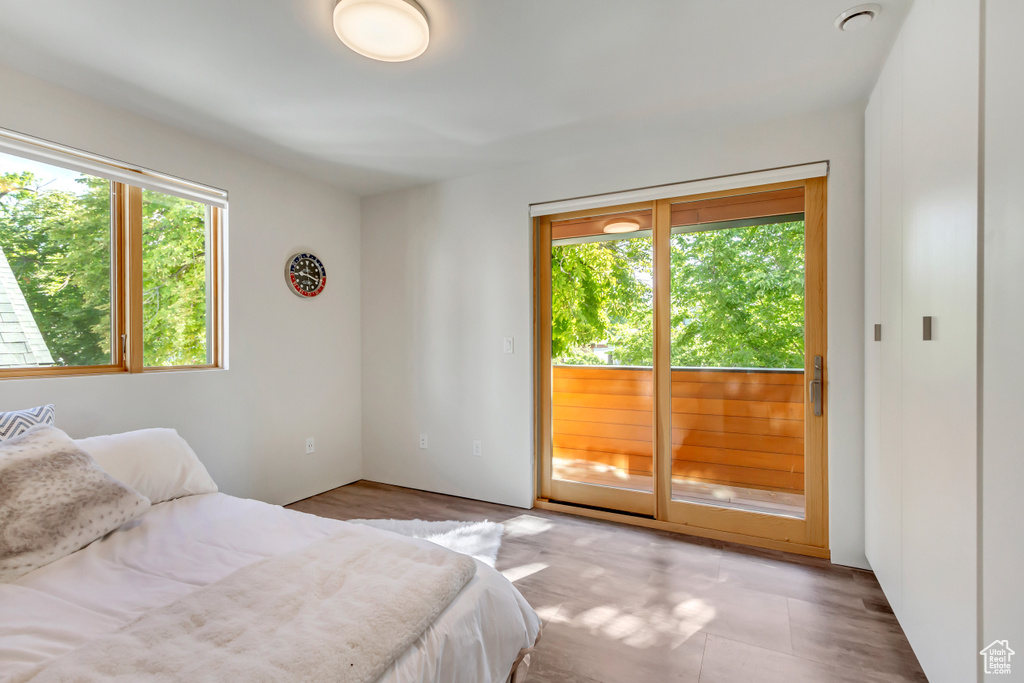 Bedroom featuring multiple windows and access to outside