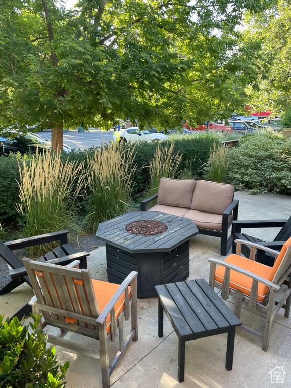 View of patio featuring an outdoor living space with a fire pit