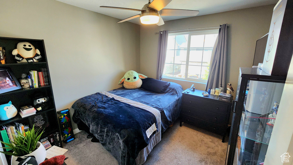 Carpeted bedroom featuring ceiling fan