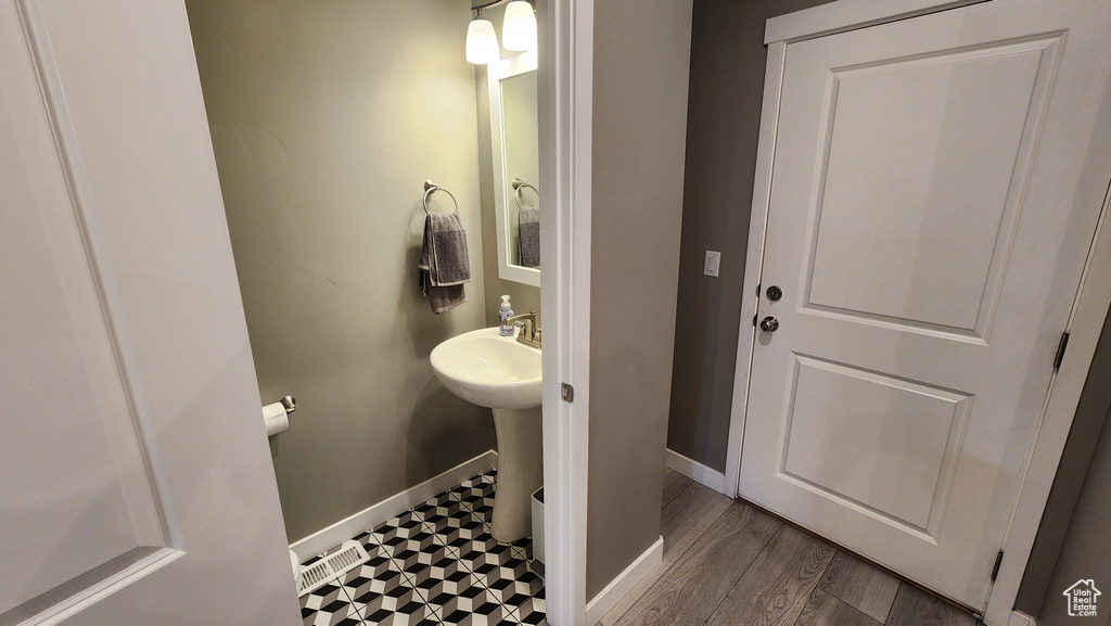 Bathroom with hardwood / wood-style flooring