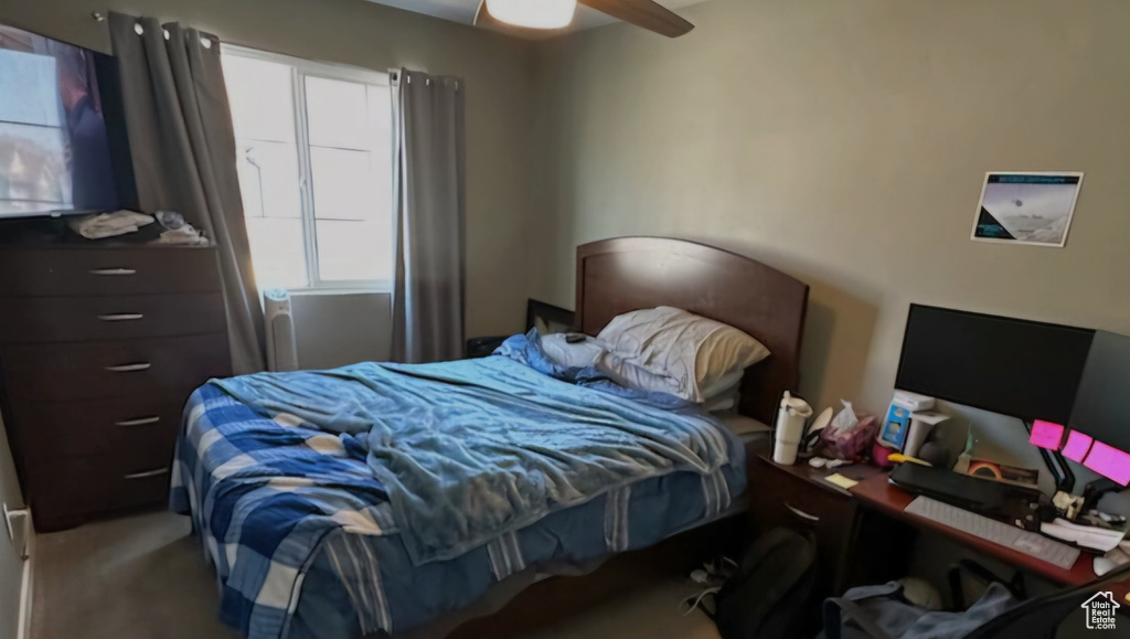 Carpeted bedroom with ceiling fan