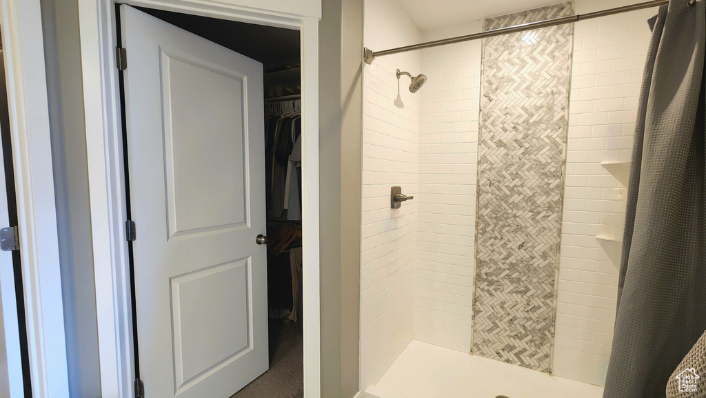 Bathroom featuring curtained shower