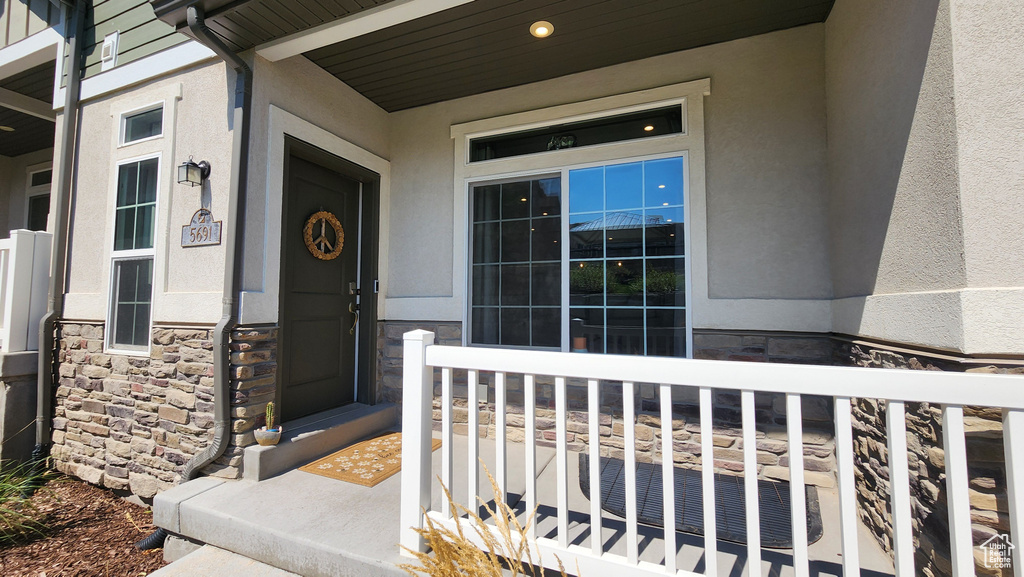 Doorway to property featuring a porch