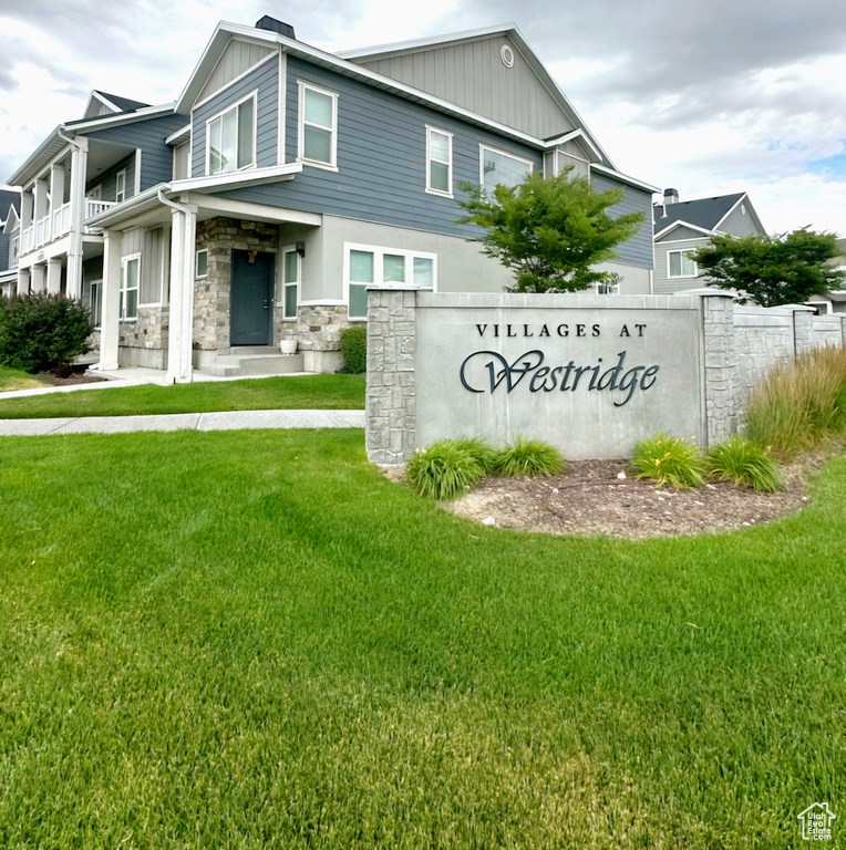 Community / neighborhood sign featuring a yard