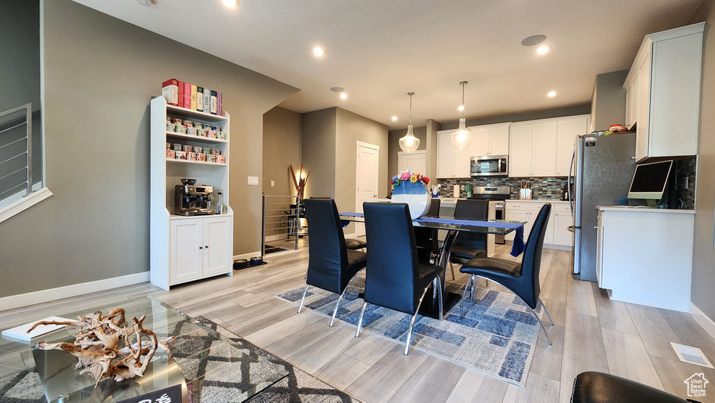 Dining area with light wood-type flooring